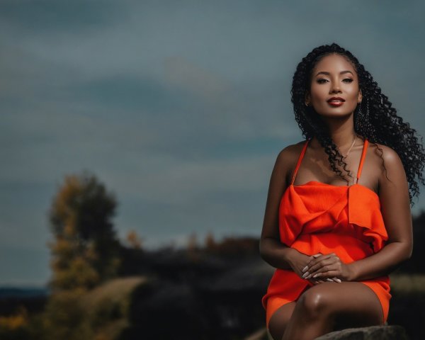 Woman in Orange Dress Surrounded by Autumn Foliage