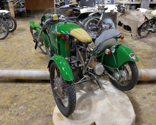Vintage Green Motorcycle with Sidecar in Workshop