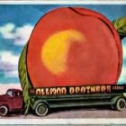 Vintage green truck under vibrant peach roadside attraction