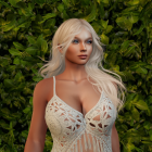 Young woman in white lace dress among lush greenery