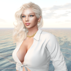 Young woman by the ocean with blonde hair and charm necklace