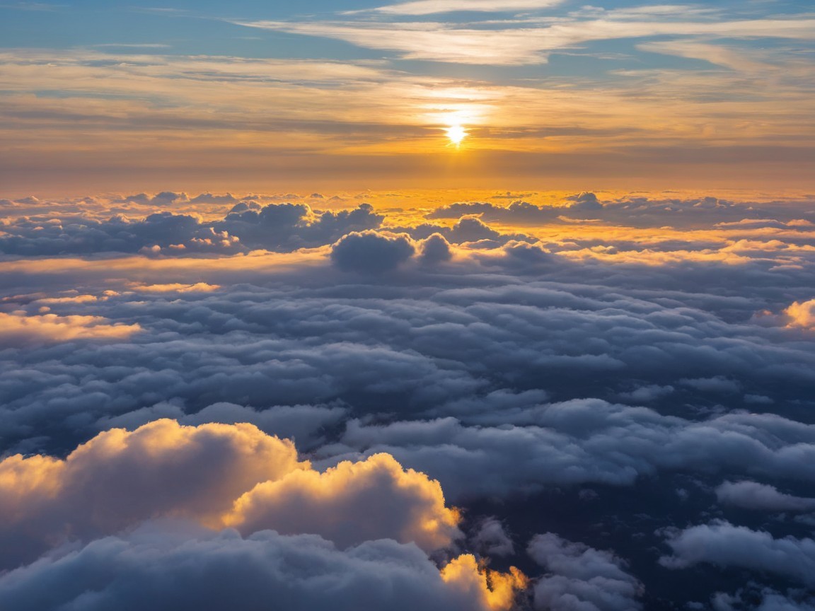 Aerial View of Sunset Above Fluffy White Clouds
