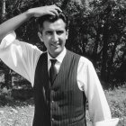 Black and white portrait of a man in a vest outdoors