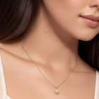 Woman wearing teardrop pendant and matching earrings