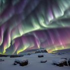 Snowy Landscape: Camping with Two Tents and Campfire under Aurora Borealis