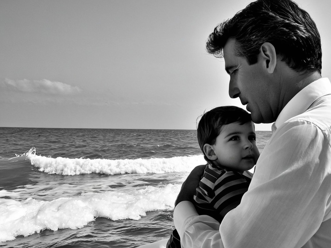 Tender Father-Son Moment by the Ocean in Black and White
