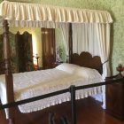 Serene Bedroom Scene with Canopy Bed and Soft Colors