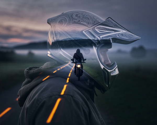 Double Exposure of Hooded Figure and Motorcycle Helmet