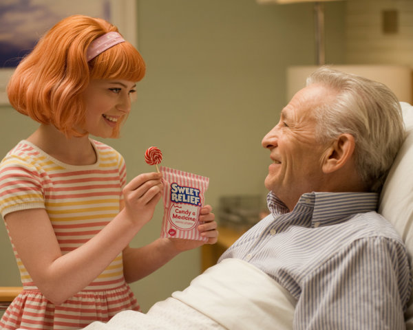 Young Girl Shares Lollipop with Elderly Man in Hospital