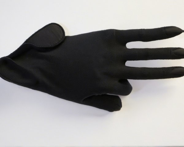 Black Glove with Fingertip Designs on White Surface