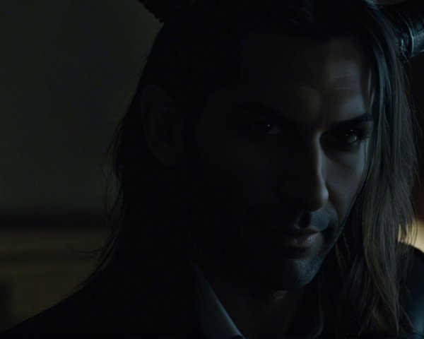 Mysterious Figure with Dark Hair and Horns in Shadows