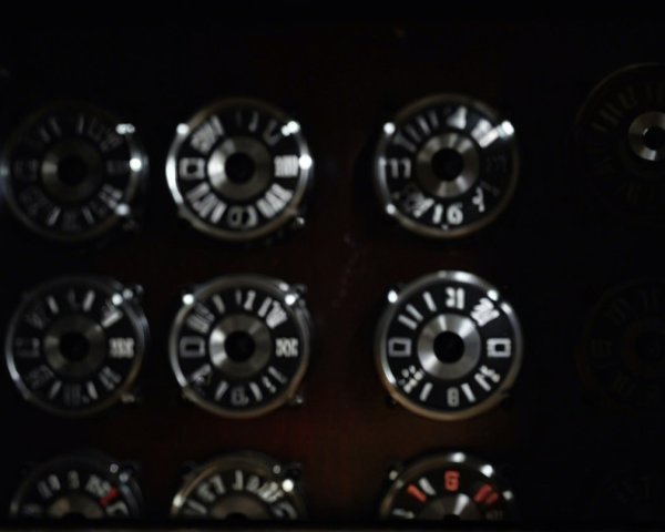 Close-Up of Metallic Dials on Dark Control Panel
