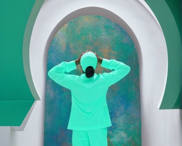 Vibrant Mint-Green Attire Against Colorful Archway