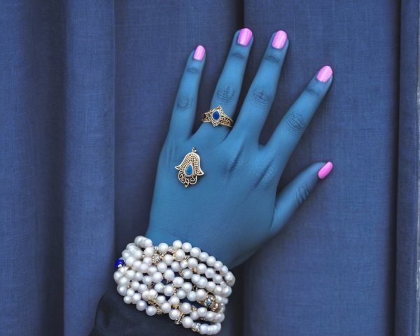 Elegant Jewelry Display on Adorned Hand with Backdrop