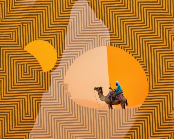 Lone Figure on Camel Amidst Geometric Desert Patterns