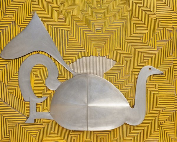 Metal Bird Sculpture with Yellow Geometric Background