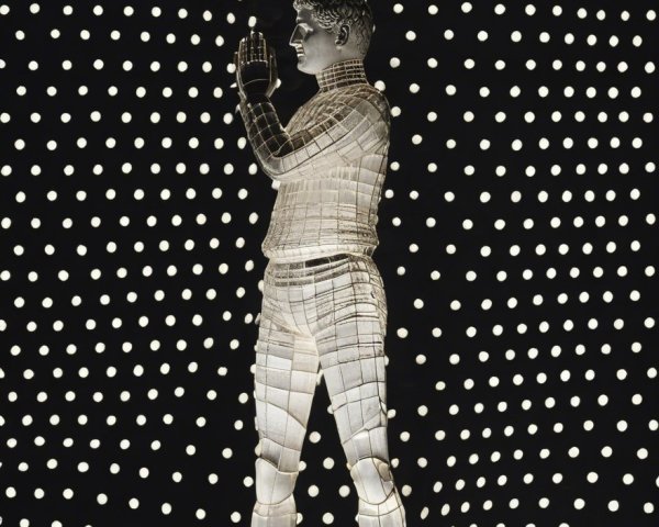 Translucent Humanoid Figure with Glowing Dots Background