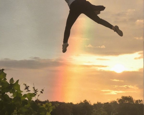 Silhouette of a Jumping Figure at Colorful Sunset