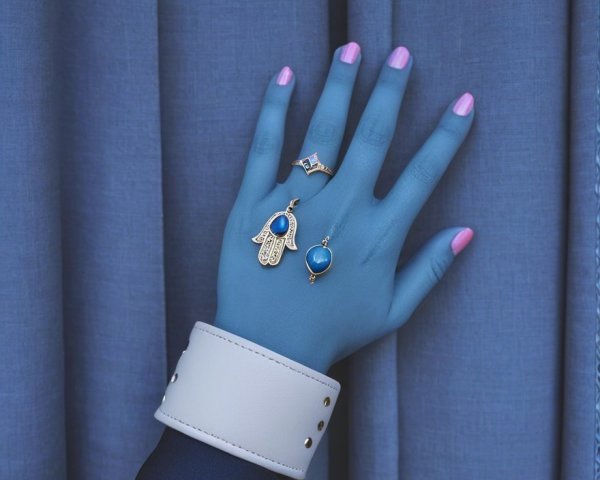 Stylized Hand with Blue Hue and Intricate Jewelry