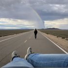 Lone Figure on Open Road Under Dramatic Sky