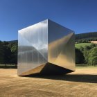 Reflective Metallic Cube in Sandy Desert Landscape
