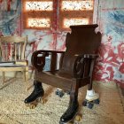 Unique Armchair with Leather Upholstery and Rustic Setting