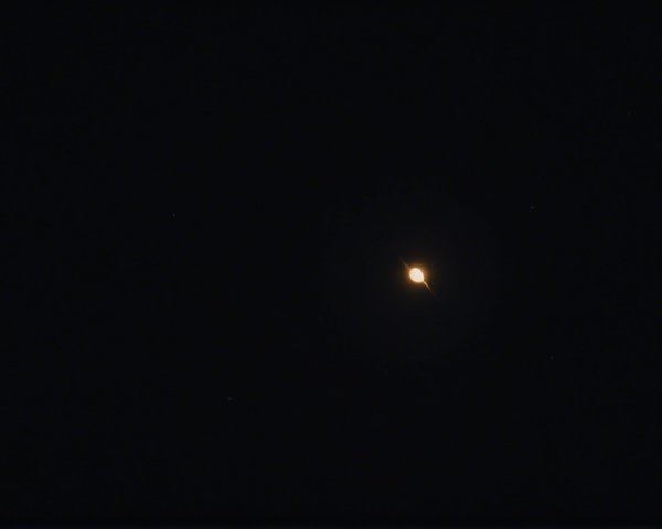 Distant Celestial Body in Dark Sky with Stars