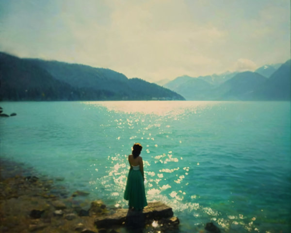 Woman in Green Dress by Serene Lake and Mountains