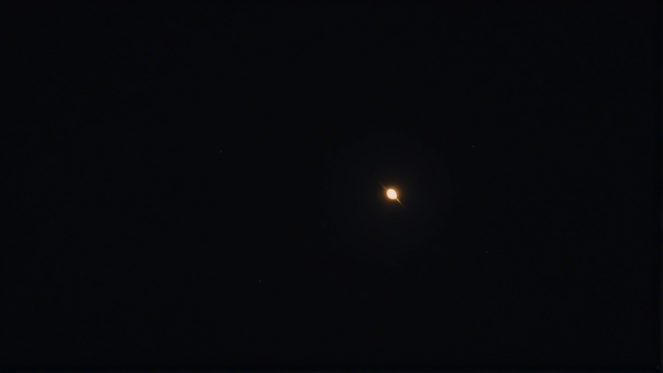 Distant Celestial Body in Dark Sky with Stars