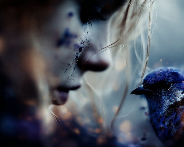 Close-up of a woman with purple speckles and a bluebird