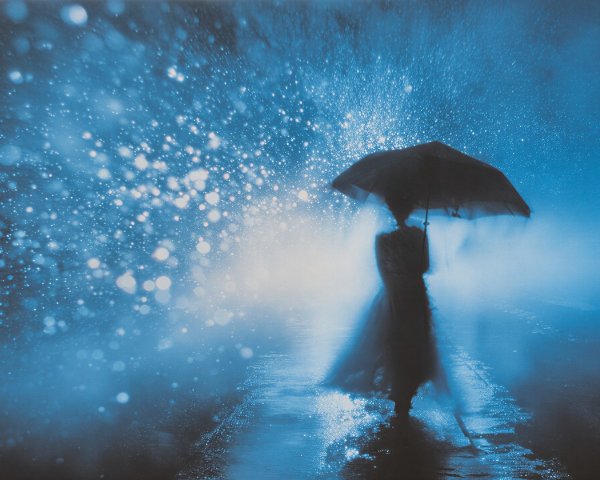 Cloaked Figure Under Umbrella in Misty Blue Scene