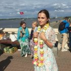Serene Maiden in Elegant Gown Surrounded by Roses