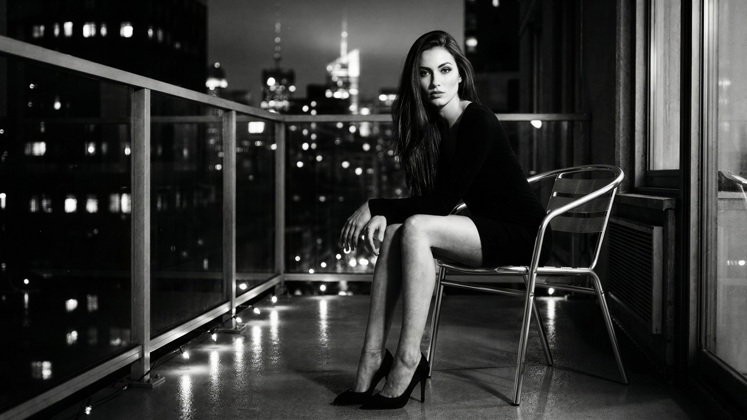 Black and white portrait of a woman on a balcony