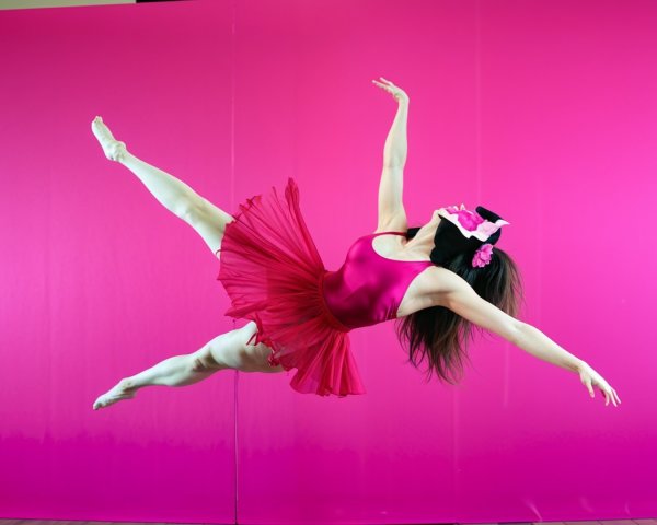 Dancer in Fuchsia Leotard Against Pink Backdrop