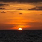 Vibrant Sunset Over Dark Ocean with Fiery Sky