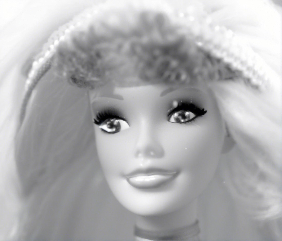 Close-up of a vintage doll with blonde hair and hat