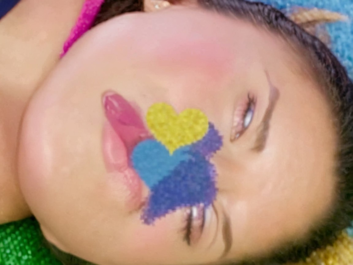 Close-up of a face with whimsical multicolored shapes