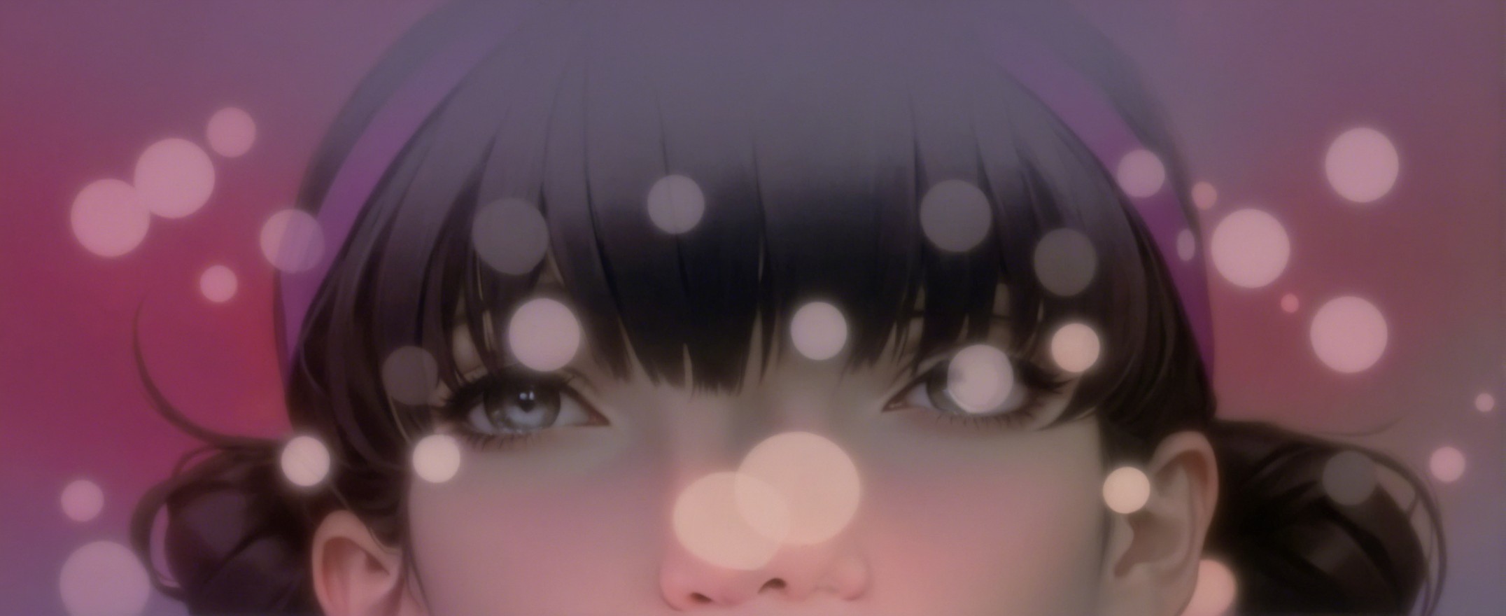 Close-up of a girl's face with pigtails and bokeh