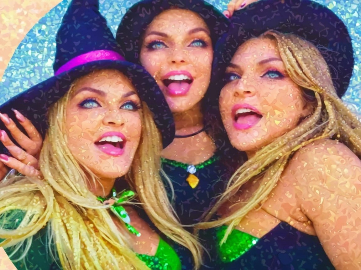 Festive Witch Costumes with Joyful Women in Sparkling Outfits