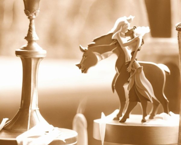 Romantic sculpture of embracing couple on horse