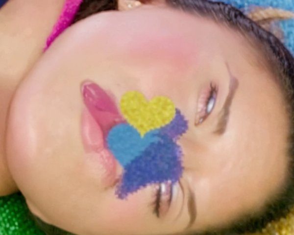 Close-up of a face with whimsical multicolored shapes