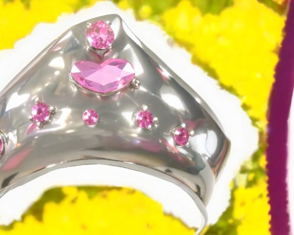 Silver Ring with Pink Gemstones and Floral Background