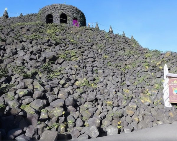 Hillside Fortress with Volcanic Rocks and Foliage