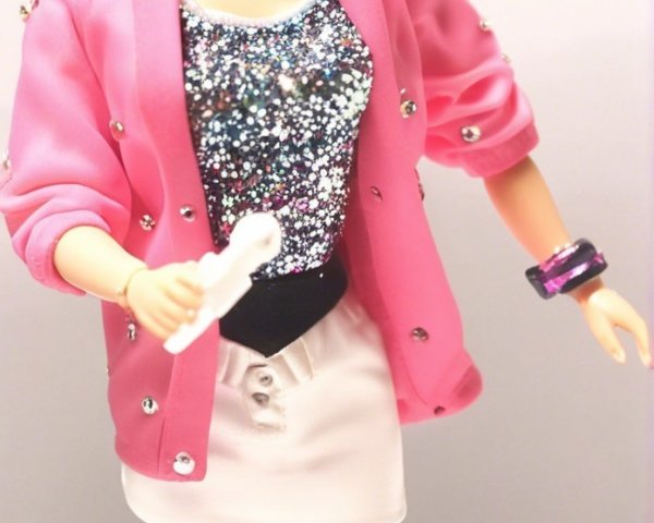 Stylish doll in pink blazer and 80s-inspired outfit