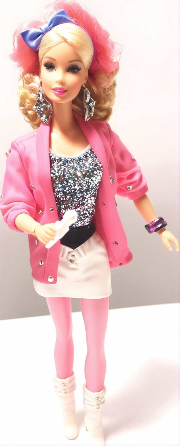 Stylish doll in pink blazer and 80s-inspired outfit