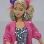 Fashionable doll in pink jacket and silver top