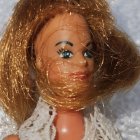 Fashion doll with blue eyes and glamorous outfit