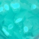 Vibrant Turquoise Wax-Like Fragments on Surface