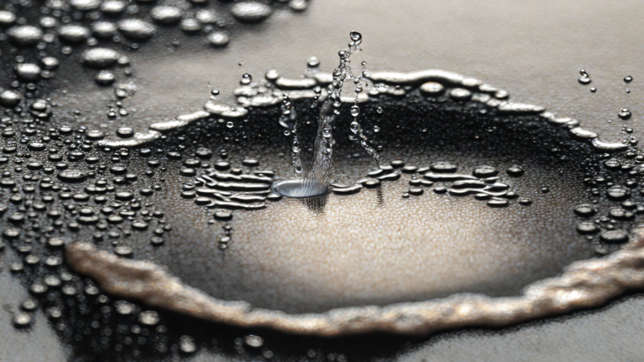 Water Droplets Creating Patterns on Reflective Surface