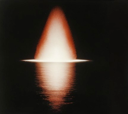 Glowing Cone of Light Over Dark Water Surface